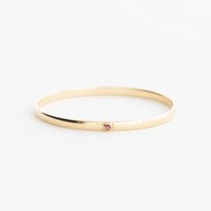 The Birthstone Milestone – Yearly Company Minimalist Birthstone Bangle Jewelry, Anniversary 14k Gold Bangle With Single Diamond, 14k Gold Bangle With Single Diamond For Anniversary, Gift Round Bangle With Bezel Setting, Round Bezel Setting Bangle Gift, 14k Gold Gemstone Bangle, 14k Gold Bangle With Gemstone, Round Bezel Set Bangle As Gift, Round Bangle With Bezel Setting As Gift