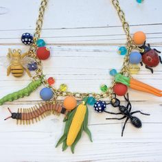 "Garden bug necklace filled with bright beads, insects and vegetable charms. Super fun and quirky necklace for insect lovers. Perfect garden lover gift.  18\"L with 3\" extension, Lenora Dame signature gold-plated cable chain with lobster clasp." Handmade Novelty Adjustable Necklace, Insect Jewelry Diy, Insect Jewelry Necklaces, Insect Jewelry Vintage, Insect Necklace, Garden Bugs, Garden Lover Gifts, Big Jewelry, Funky Earrings