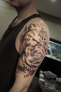 a man with a clock and rose tattoo on his arm