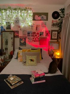 a cat sitting on top of a bed in a room with many pictures and lights