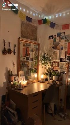 a desk with a mirror and some plants on it in a room filled with lights