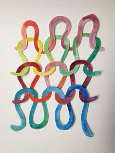 colorful paper clips are arranged in the shape of letters on a white surface, with one letter missing