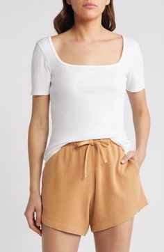 Solid and stretchy, this ribbed top will achieve staple status as you wear it year-round. 23 1/2" length (size Medium) Scoop neck Short sleeves 55% cotton, 40% modal, 5% spandex Machine wash, dry flat Imported Basic Summer Tops With Ribbing, Basic Ribbed Tops For Summer, Basic Ribbed Summer Tops, White Ribbed Square Neck Top, Fitted Ribbed Tops For Loungewear, Scoop Neck Stretch Top With Ribbing, Spring Ribbed Scoop Neck T-shirt, Stretch Scoop Neck Top With Ribbing, Square Neck Ribbed Stretch Tops