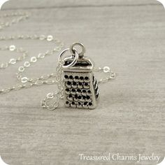 This Cheese Grater Necklace comes on a sterling silver chain that is available in different lengths. Please choose your desired length from the drop-down menu when placing the item in your shopping cart. { CHARM DETAILS }★ Material: .925 Sterling Silver★ Finish Color: Silver★ Measurements: 1/4" x 1/2"★ Dimensions: 3-Dimensional★ Made in the USA{ SIMILAR ITEMS } More food and kitchen themed items available from my shop: https://www.etsy.com/shop/treasuredcharms/search?search_query=food{ GIFT OPTI Themed Stainless Steel Jewelry As Gift, Themed Silver Stainless Steel Jewelry, Silver Themed Pendant Jewelry, Themed Silver Pendant Jewelry, Themed Sterling Silver Necklace, Silver Themed Necklace For Gift, Themed Sterling Silver Necklace In Silver, Themed Sterling Silver Nickel Free Necklaces, Themed Silver Necklace For Gift