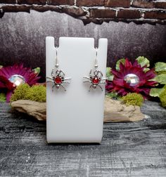 "These earrings features cool tiny spider charms with red rhinestones in them. They are on silver plated ear wires. Small but so cute! Earrings are 1 1/2\" total length and 3/4\" wide *Color may vary slightly due to camera flash or individual computer monitors Store policies: https://www.etsy.com/shop/eternalnightboutique#policies Back to the shop: https://www.etsy.com/shop/eternalnightboutique" Red Nickel-free Jewelry For Halloween, Nickel-free Red Halloween Jewelry, Red Novelty Jewelry For Halloween, Red Pierced Halloween Earrings, Red Pierced Earrings For Halloween, Red Drop Earrings For Halloween, Red Earrings As Halloween Gift, Red Metal Halloween Earrings, Red Earrings For Halloween Gift