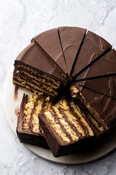 there is a chocolate cake on the plate with slices cut out and ready to be eaten