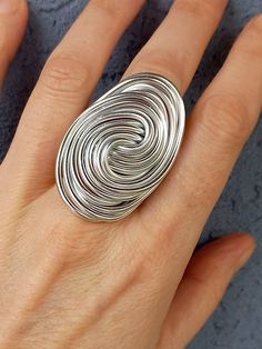 Elevate your style with this one-of-a-kind handcrafted aluminum wire ring in a stunning silver hue.  Made from high-quality aluminum, the ring features an intricate wire wrapping technique that adds a touch of elegance and uniqueness to your jewelry collection.  The lightweight nature of the material ensures comfort, making it ideal for everyday wear or special occasions. The package will be sent as soon as possible (1-3 days) after purchase. Feel free to contact me if you have any questions abo Silver Wire Wrapped Swirl Jewelry, Silver Wire Wrapped Jewelry With Swirl Design, Silver Swirl Wire Wrapped Jewelry, Unique Spiral Metal Rings, Silver Spiral Wire Wrapped Rings, Silver Twisted Metal Jewelry, Twisted Silver Metal Jewelry, Nickel-free Spiral Silver Rings, Nickel-free Silver Spiral Rings