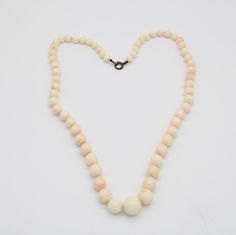 This is an incredible necklace made of Angel skin coral shell. Mostly white in color with some minor coral/pinkish tones. The beads are graduated with the center being the largest at approx 12 mm (see photo). Condition; Good vintage condition, no chips or visible damage. Clasp has a heavy patina due to age. Size; The largest bead is about 12mm, the next size down is about 10mm and the length of the necklace is approximately 22 inches long. Hallmarks; Clasp is sterling silver (tested) but there i Beaded Necklace White, Angel Skin, Coral Beads Necklace, Necklace White, Sunset Beach, Coral Beads, Silver Flowers, Chain Ring, Sterling Ring