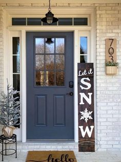 the front door is decorated for christmas with holiday decorations on it and a welcome mat