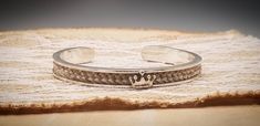 PLEASE READ ENTIRE LISTING BEFORE PLACING YOUR ORDER AND SEND ME A MESSAGE WITH ANY QUESTIONS. Beautiful, custom solid sterling silver cuff horsehair bracelet handmade from your horse's hair or my stock hair. Available as completely sterling silver or with 14k gold crown centerpiece. Gold option is not routinely kept in stock, but can easily be ordered from my supplier. PLEASE NOTE: ENGRAVING IS NOT AVAILABLE THROUGH ME FOR THESE BRACELETS. I CAN ONLY OFFER ENGRAVING ON SOLID BAR CENTERPIECE STY Luxury Sterling Silver Engraved Cuff Bracelet, Luxury Engraved Sterling Silver Cuff Bracelet, Luxury Adjustable Sterling Silver Bangle, Custom Adjustable Sterling Silver Jewelry, Custom Silver Handmade Bracelets, Handmade Custom Silver Bracelets, Luxury Silver Stamped Jewelry, Luxury Stamped Silver Jewelry, Handmade Luxury Sterling Silver Bangle