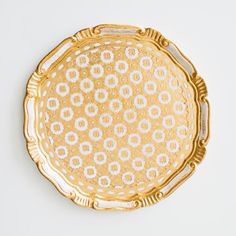 a gold plate with white designs on it