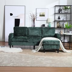 a living room with a green couch and white rug