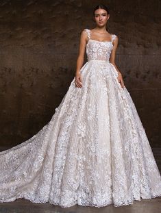 a woman in a white wedding dress posing for the camera with her hands on her hips