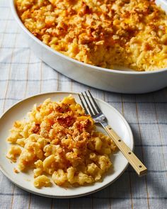 macaroni and cheese casserole on a plate with a fork next to it