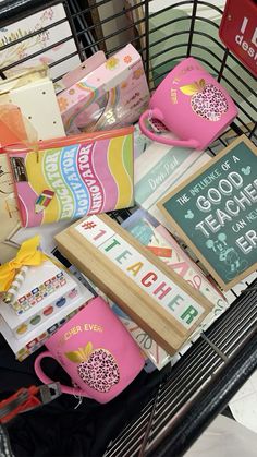 a shopping cart filled with books and coffee mugs