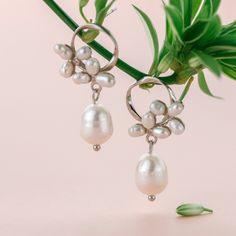 An elegant pair of floral pearl earrings features a baroque pearl dangle tear drop on dainty stud earrings, comes in gold or silver color. These elegant pearl drop earrings are perfect wedding jewelry gift, simple bridal earrings, or everyday earrings gift for your love one. Materials are solid 925 sterling silver with gold plate or platinum plate and pearls. *Pearls are natural so shape and size maybe vary a little bit. Jewelry Care: See more information about how to care for your jewelry here. Delicate Pearl Earrings With Pearl Pendant, Delicate Pearl Earrings With Pendant, Feminine Pearl Drop Flower Earrings For Formal Occasions, Feminine Pearl Drop Flower Earrings, Elegant Pearl Charm Chandelier Dangle Earrings, Elegant Pearl Charm Chandelier Earrings, Elegant White Cluster Earrings With Pearl Drop, Elegant White Pearl Drop Cluster Earrings, Delicate Pearl Charm Flower Earrings