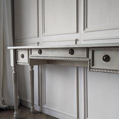 a white desk with two drawers on it