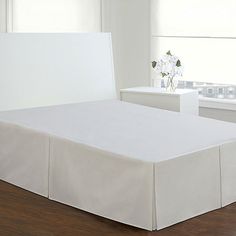 a bed with a white sheet on top of it