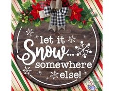 a wooden sign that says let it snow somewhere else with poinsettis and bows