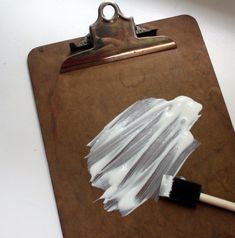 a clipboard with a paint brush on it