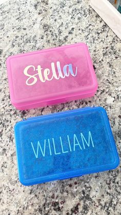 two personalized plastic name plates sitting on top of a granite countertop next to each other