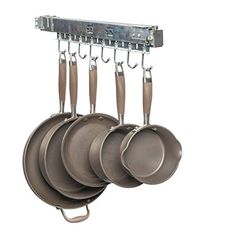 an assortment of pots and pans hanging from hooks