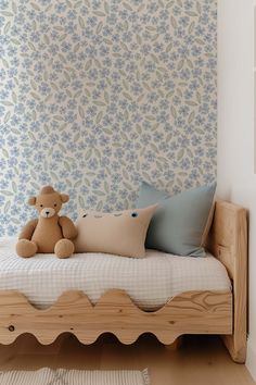 a teddy bear sitting on top of a wooden bed