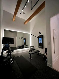 an empty room with mirrors and lights on the ceiling, black carpeted flooring