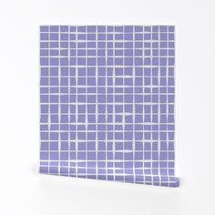 a purple and white tile pattern on a wall