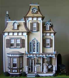 a large doll house with lots of windows