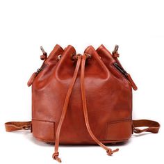 The Tulip Leather Vintage Bucket Bag is made of high-quality, full-grain leather, and its authentic vintage flair makes it a beautiful yet functional tote option for travel and every-day use. Boasting a large carry volume and two color options, the Tulip Leather Vintage Bucket Bag allows for quick and easy access to your belongings through two side-zip compartments. This unique bucket bag combines fashion and function to suit all of your work, travel, school, and other carry needs. Made of 100% New Year Promotion, Vintage Bucket, Tassels Fashion, Women Bags Fashion, Genuine Leather Handbag, Leather Bucket Bag, Leather Bucket, Shoulder Tote, Vintage Leather