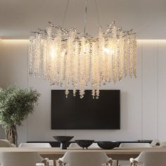 an elegant dining room with chandelier and white chairs in front of a flat screen tv