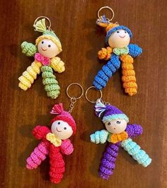 three crocheted dolls are hanging from key chains