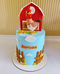 there is a cake that has a chicken on the top and farm animals on it