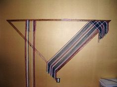 an empty room with a striped scarf hanging on the wall