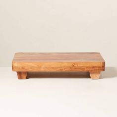 a wooden bench sitting on top of a white table