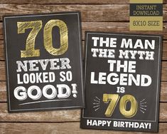 two black and gold 70th birthday cards on wooden background