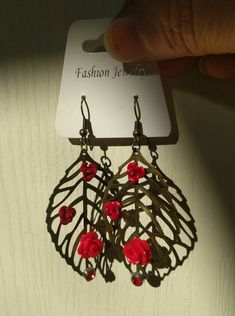 Red flowers, Leaves filigree leaf earrings. Boho leaf loops. Bronze metal ear hook. Leaf filigree bronze colored metal. Red aluminum flowers. Red rhinestone. Length with hook: approximately 7 cm. The earrings can be worn on any occasion. Hand crafted with new materials. Comes in an organza bag. Her Earrings can be a gift for a friend or for yourself. In the package I enclose a gift wrap envelope. Sent in a bubble bag to with tracking number. Do not shower with loops. Store them in a dry place. T Affordable Red Bohemian Flower Earrings, Leaf Filigree, Boho Leaves, Flowers Red, Bubble Bag, Silver Line, Bronze Metal, Earrings Red, Red Rhinestone