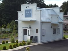 a white building with a sign that says molo coffee on it's side