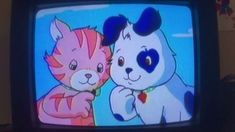 an old television with two cartoon cats on it's screen and one cat holding the other