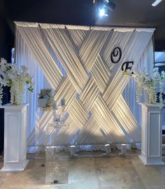 an image of a stage set up for a wedding ceremony with flowers on the side