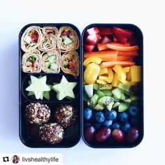 two bento boxes filled with fruit and veggies on top of each other