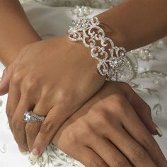 the bride and groom are holding each other's hands with their wedding rings on them