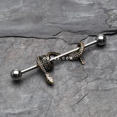 a metal ball and snake design barbell ring