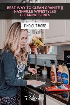 a woman is cleaning the kitchen counter with her hand and looking at something in front of her