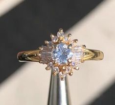 a diamond ring sitting on top of a metal pole