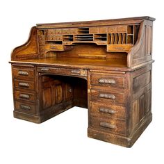 an old fashioned wooden desk with drawers and file cabinets on it's top shelf