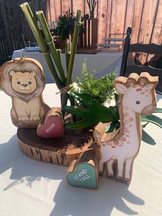 a table topped with wooden animals and plants