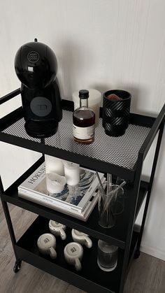 a black shelf with various items on it