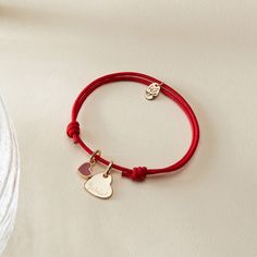 Our Personalized Valentines Heart Bracelet is a sweet symbol of love and affection, perfect for Valentine's Day and beyond. Each bracelet features two charms: a dainty and romantic mini red heart, and a shiny heart charm to hand-engrave with the name of a true love. Both charms move freely along your choice of colorful braid.18K Champagne Gold Plated or 925 Sterling SilverHeart: 0.4x 0.4Mini Red Lacquer Heart: 0.25 x 0.21Braid made of a durable, colourfast polyesterFully adjustable sliding knot Red Heart Charm Bracelet For Friendship, Personalized Red Heart Bracelet, Dainty Name Bracelet With Heart Charm For Valentine's Day, Dainty Heart Charm Name Bracelet For Valentine's Day, Valentine's Day Adjustable Name Bracelet With Heart Charm, Adjustable Heart Charm Name Bracelet For Valentine's Day, Adjustable Name Bracelet With Heart Charm For Valentine's Day, Valentine's Day Double Heart Adjustable Charm Bracelet, Adjustable Double Heart Charm Bracelet For Anniversary